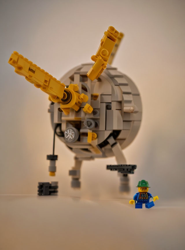 LEGO satellite model with dish antenna and astronaut figure