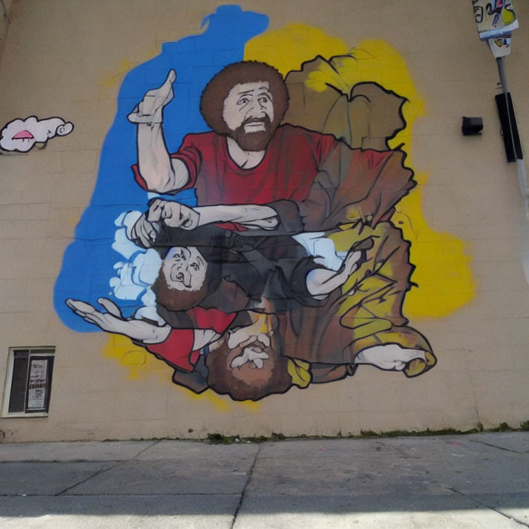 Vibrant street mural: Identical bearded figures, one upright, one upside-down, on