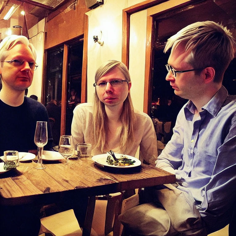 Three People with Matching Hairstyles Dining at Restaurant Table