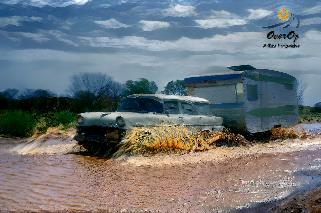 EK Holden towing a caravan on a flooded dirt road