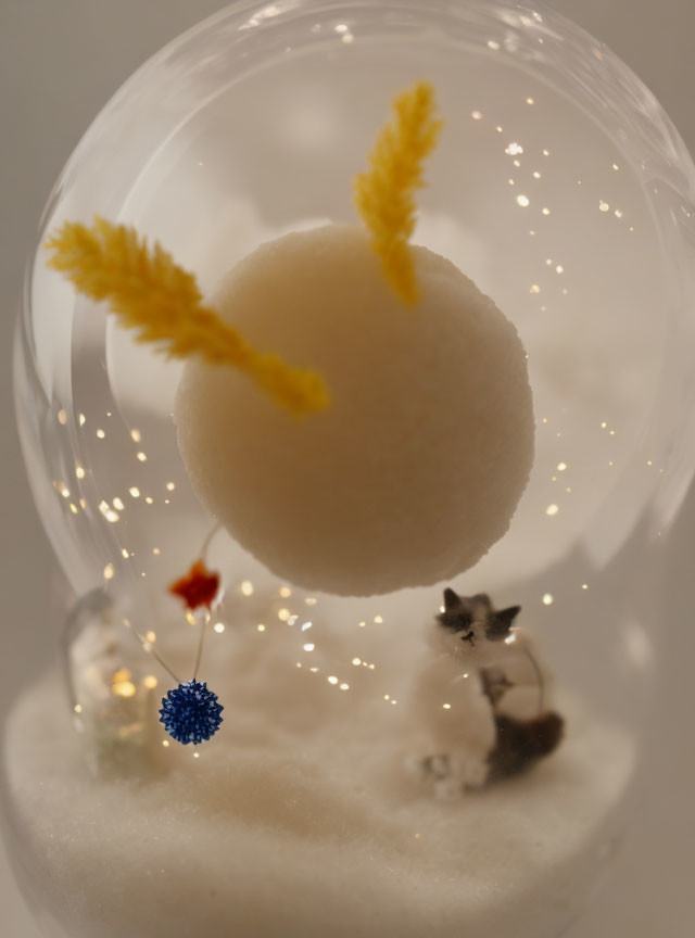 Whimsical snow globe with floating white ball and sparkling lights