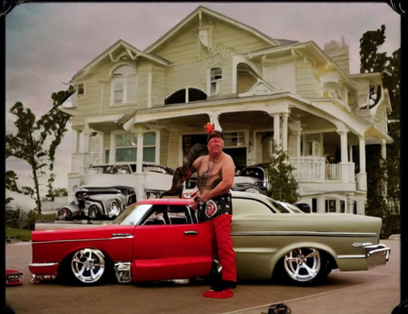 Person in red outfit leaning on classic lowrider car in front of vintage house