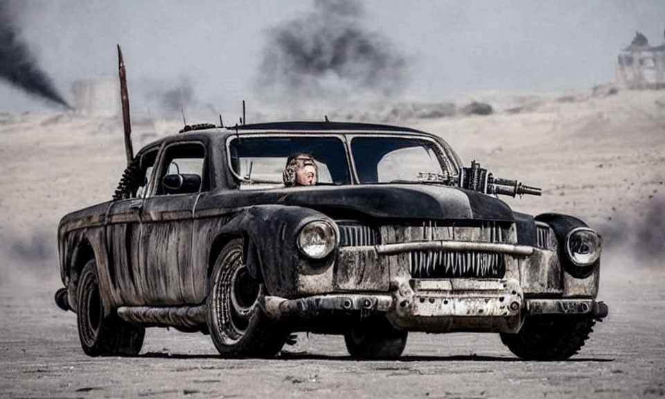 Vintage car with mounted gun driving through barren landscape