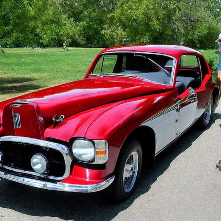 Vintage Red Car with Unique Front Grille Design and Chrome Accents