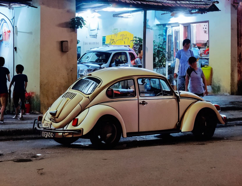 Vintage Cream Volkswagen Beetle Parked on Busy Street at Dusk