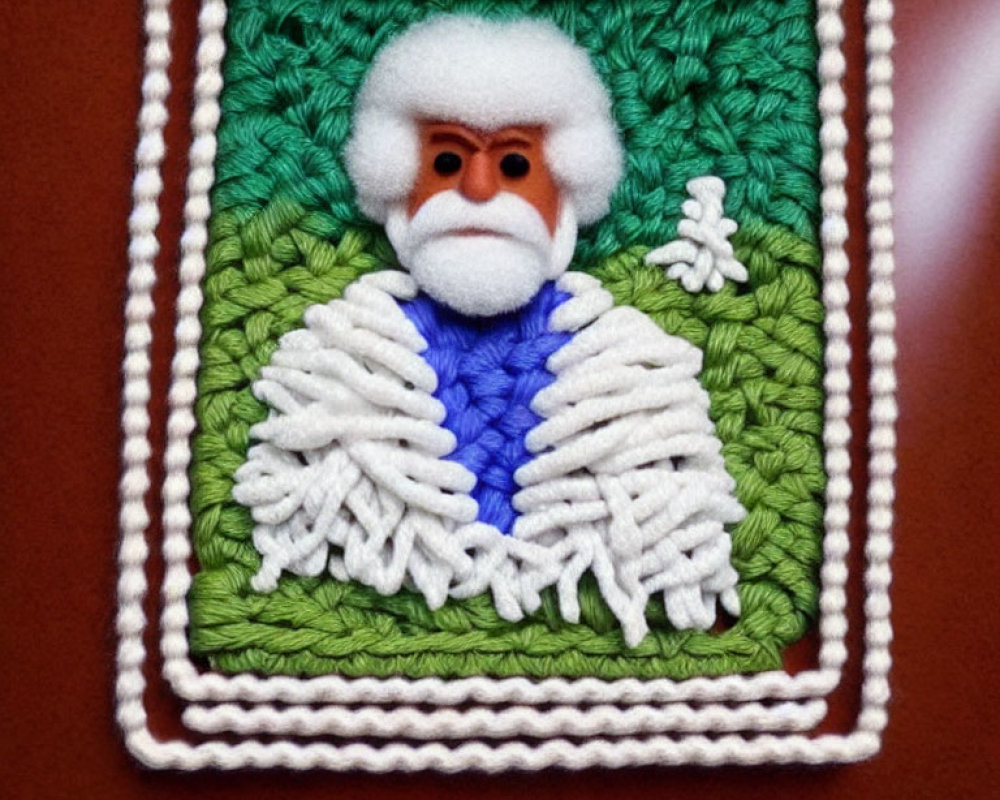 Textured craft portrait of character with white beard and blue outfit on green background.