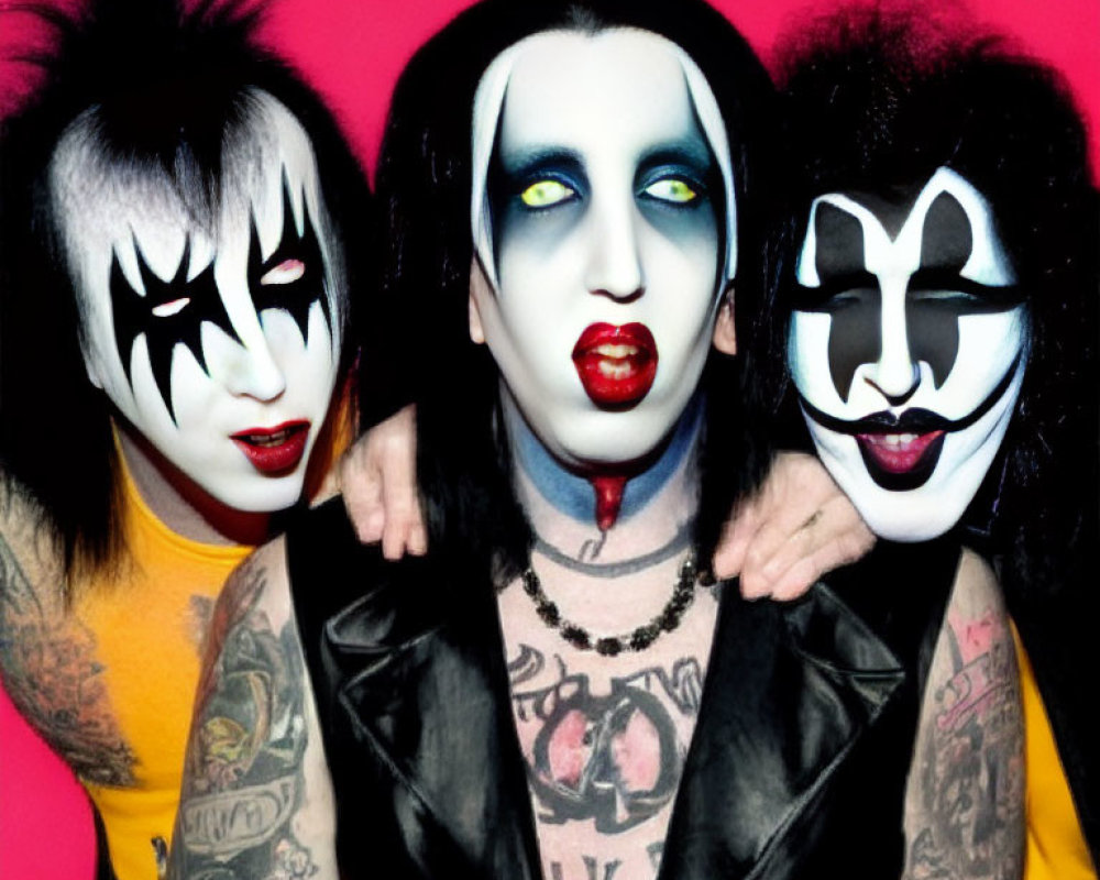 Three individuals with KISS-inspired makeup on pink background