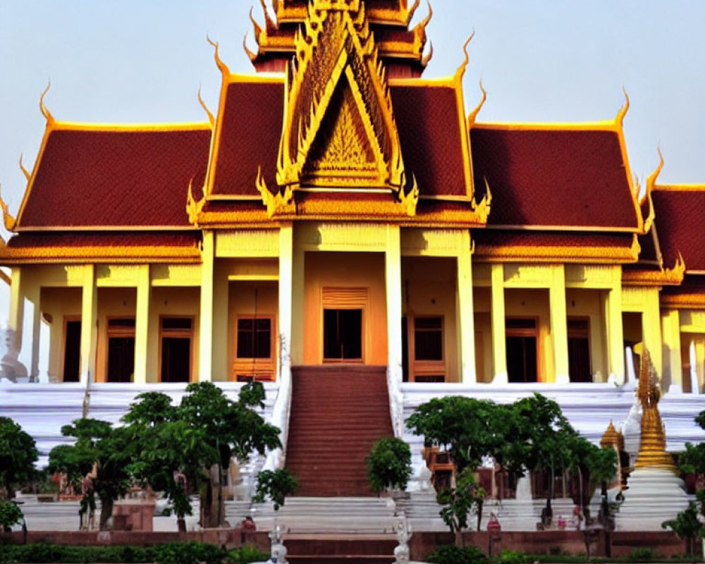 Traditional Golden-Roofed Temple with Red Steps in Southeast Asian Architecture