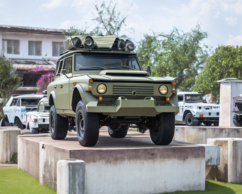 Military-style green vehicle with roof-mounted rocket launcher on concrete platform