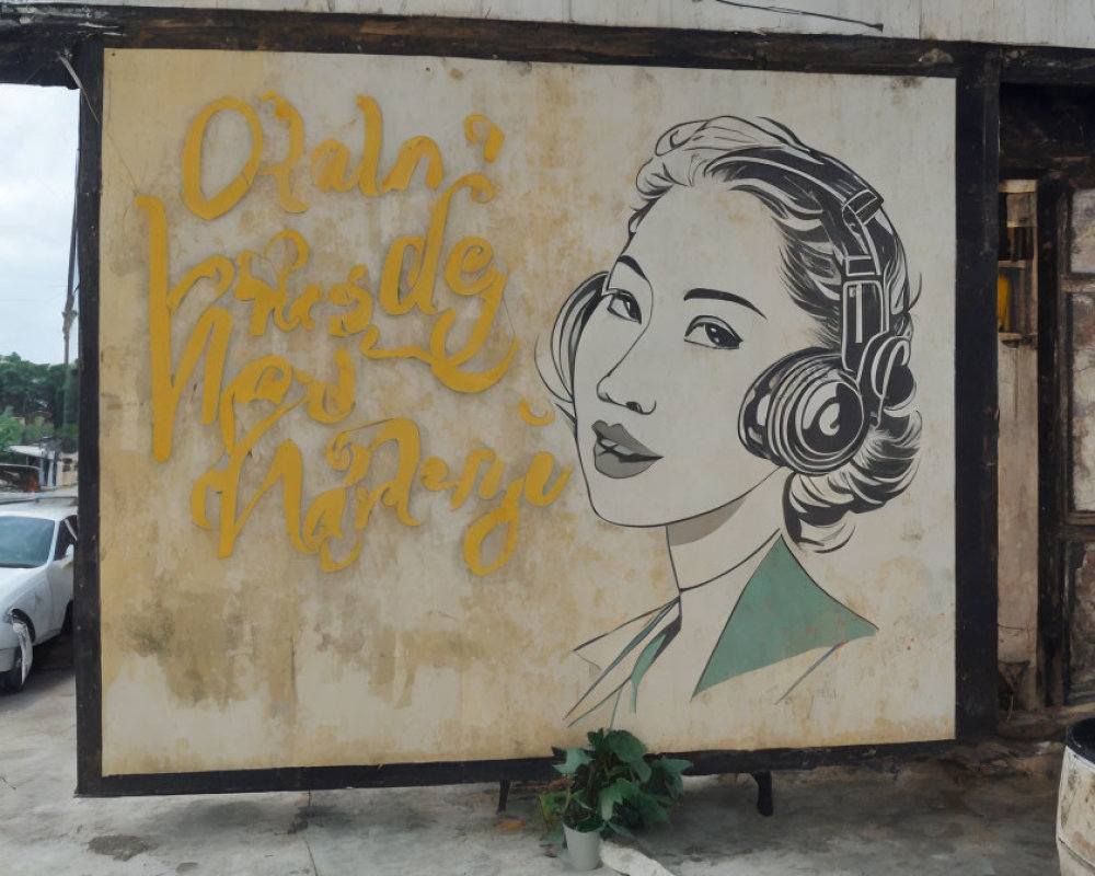 Weathered mural of woman with headphones and elegant hair and stylized script phrase.