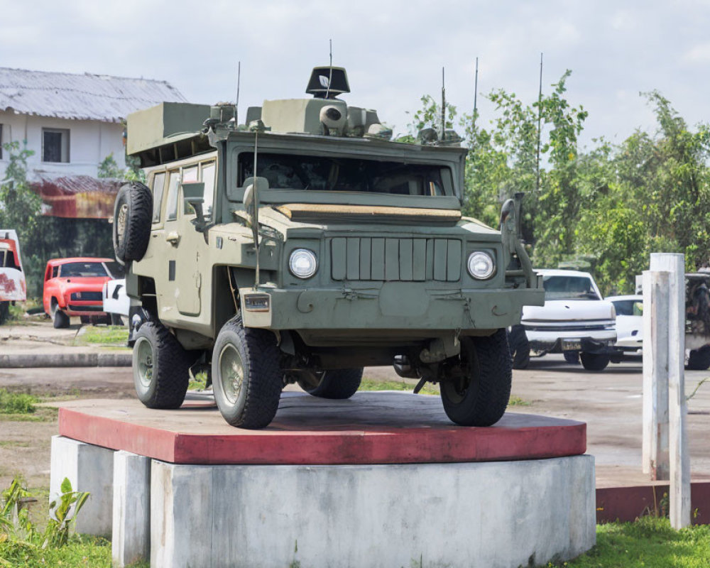 Armored Personnel Carrier on Concrete Pedestal in Peaceful Setting