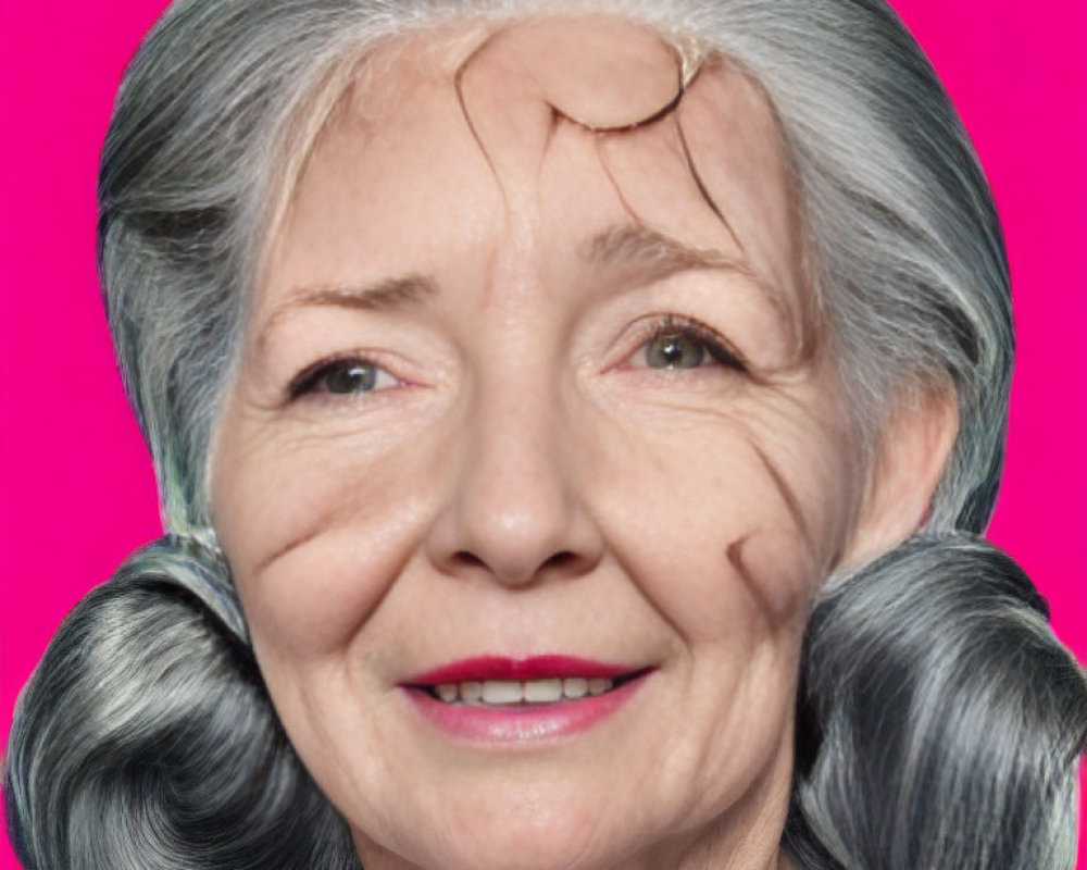 Smiling elder woman with gray hair in round buns on pink background