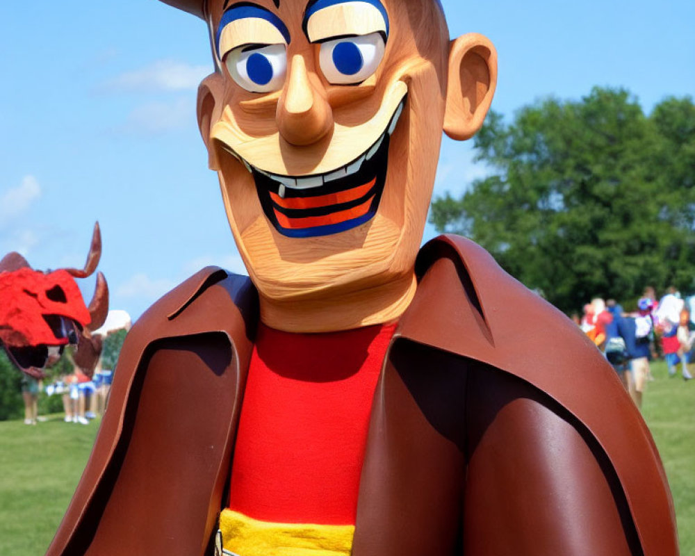 Person in Woody Toy Story costume with large head, cowboy hat, and red bandana outdoors