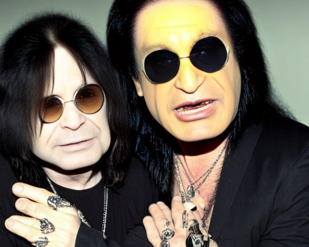 Two Men with Long Black Hair in Stylish Black Attire and Sunglasses