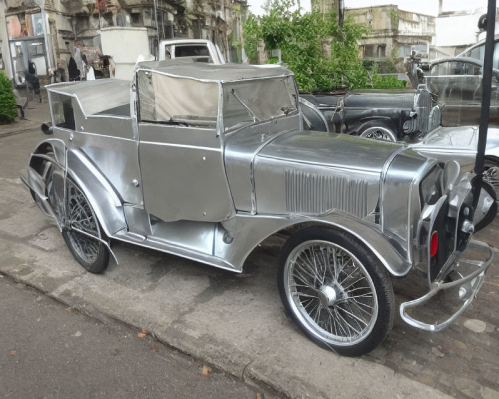 Classic Silver Convertible Car with Spoke Wheels on Outdoor Display