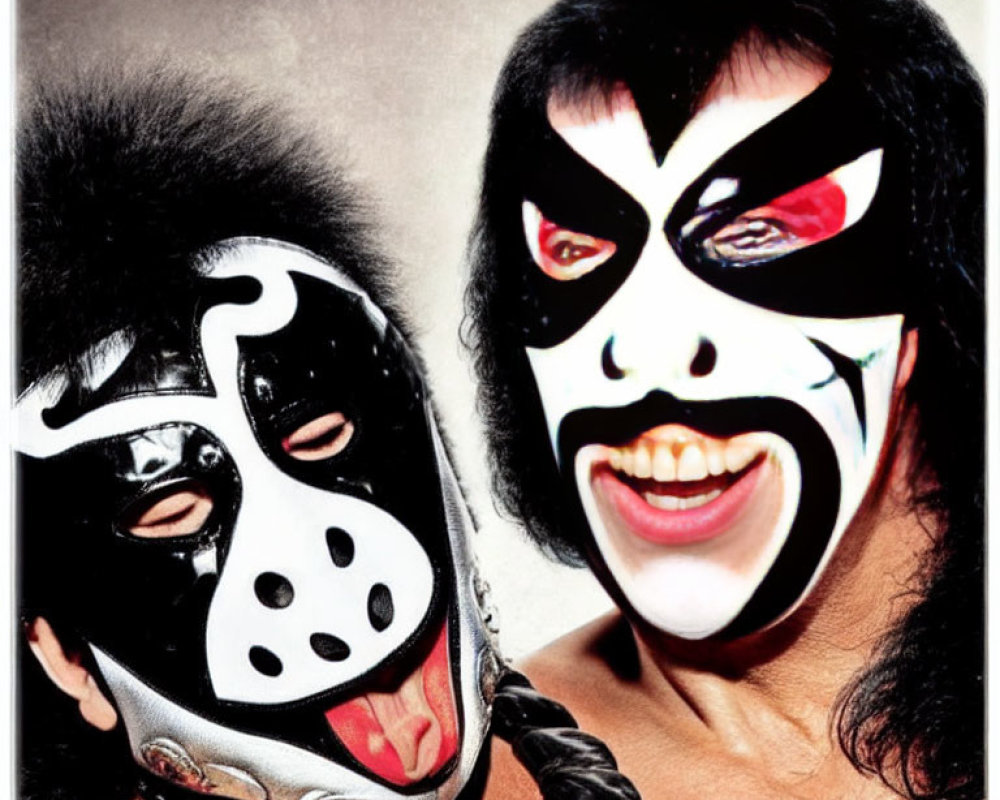 Dramatic black and white face paint duo sticking out tongues
