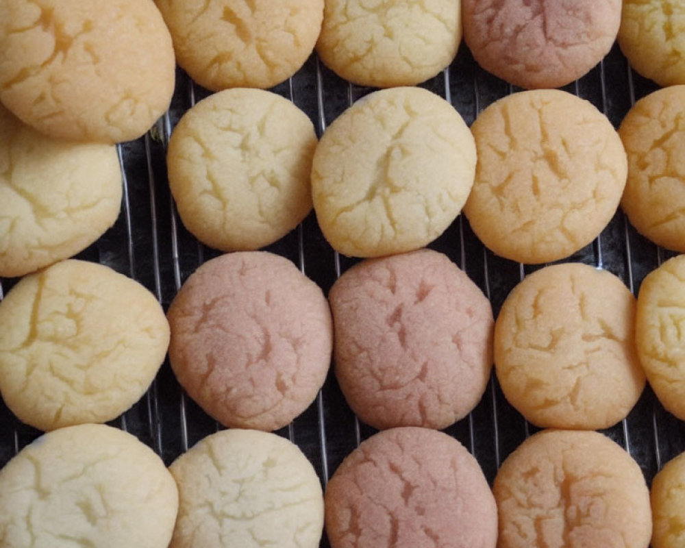 Round Cookies Cooling on Wire Rack with Golden Brown and Light Pink Hues