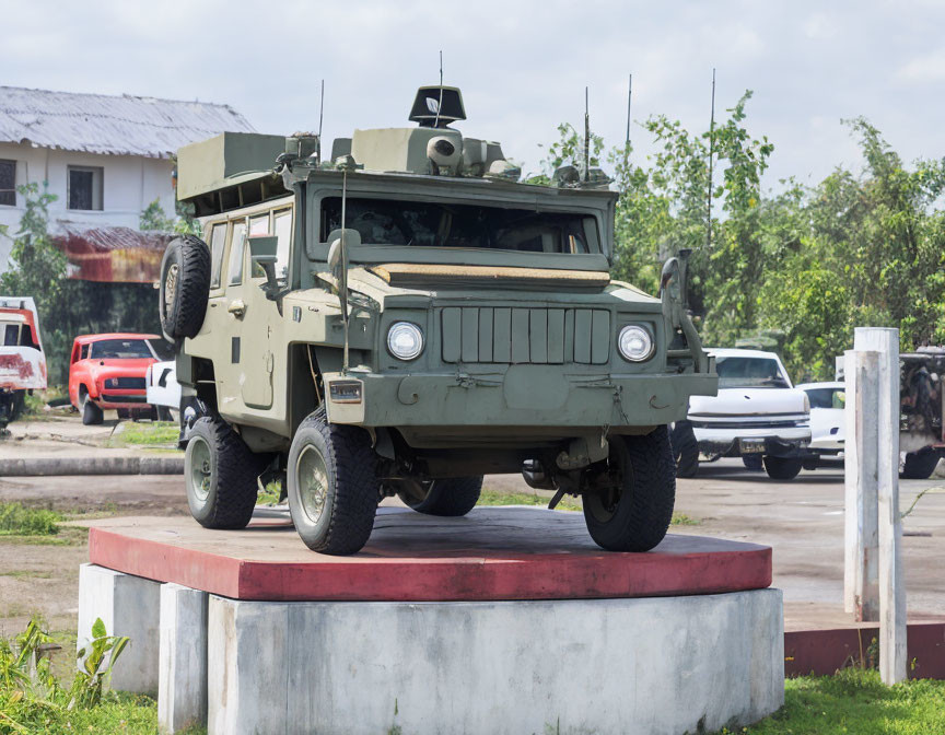 Armored Personnel Carrier on Concrete Pedestal in Peaceful Setting