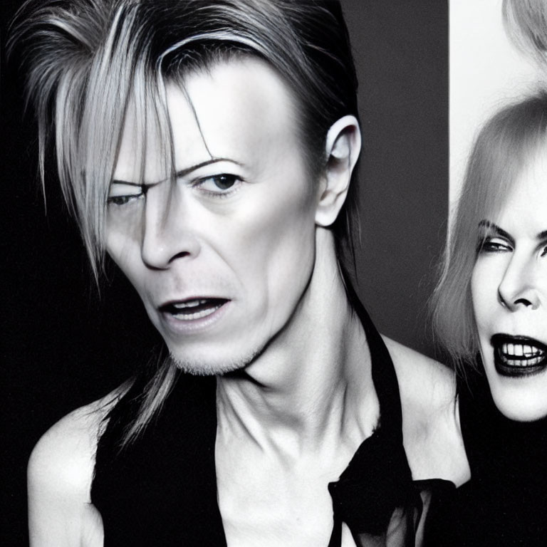 Monochrome photo of two individuals with bold makeup and edgy hairstyles