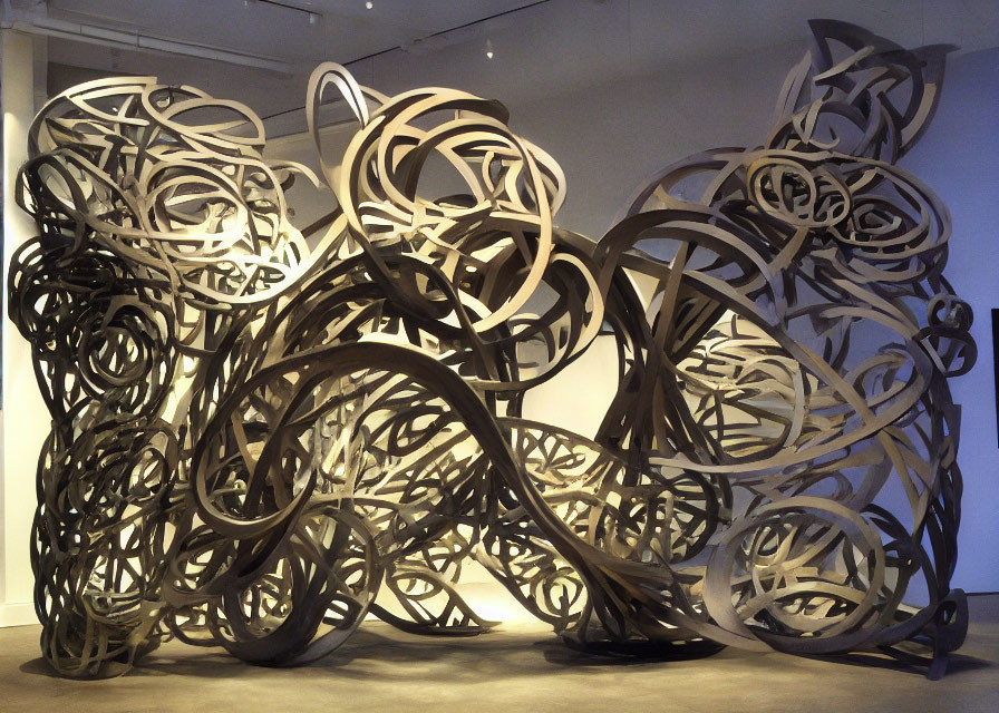 Large-Scale Metal Sculpture with Intricate Loops and Swirls in Gallery