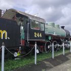 Vintage Black Steam Locomotive with Intricate Details on Tracks