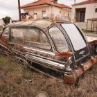 Collection of Vintage Cars Parked Near Dilapidated Buildings
