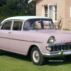 Vintage 1957 Chevrolet Bel Air in Pink and White on Grassy Lawn