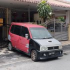 Customized Black Van with Red and White Graphics in High-Tech Workshop