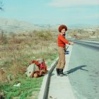 Men measuring on road with mountains in the background