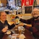 Elderly men socializing at a Japanese bar with traditional decor