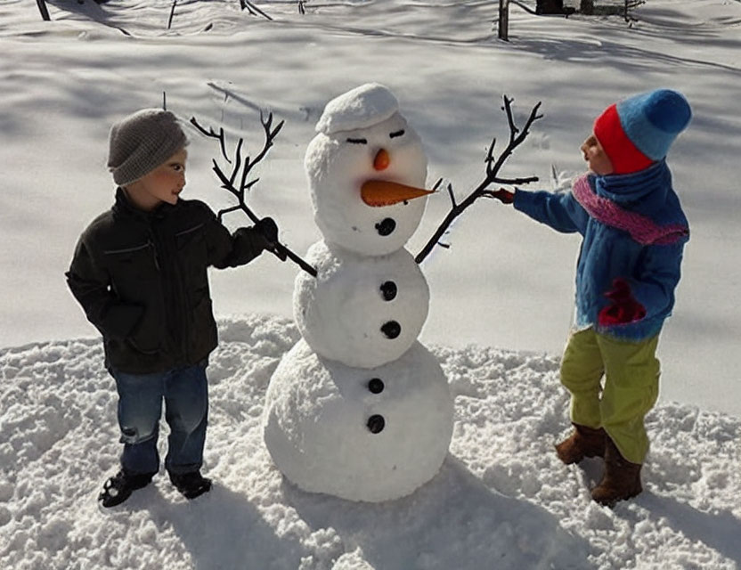 Children in winter attire beside snowman in snowy landscape