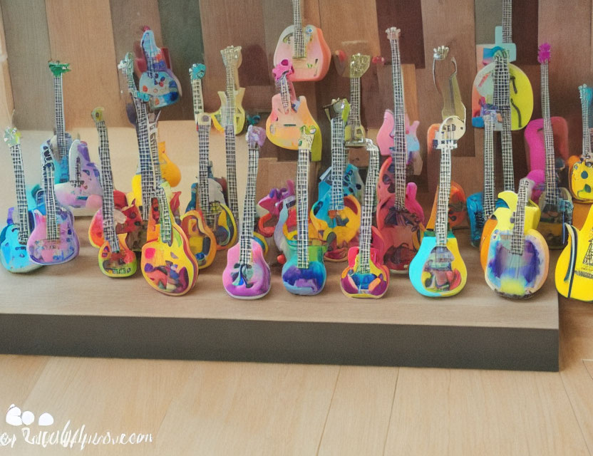 Colorful Miniature Guitar Collection Displayed on Wooden Shelf