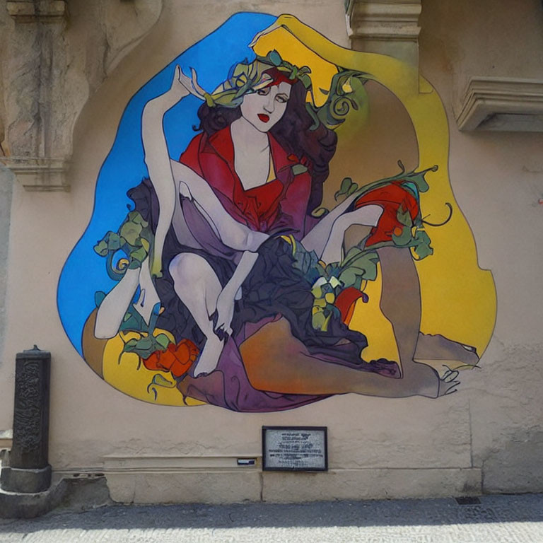Vibrant woman mural with vines on urban wall and plaque