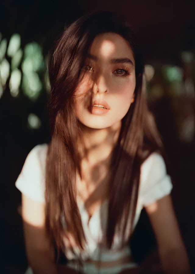Portrait of Woman with Long Hair and Striking Eyes in Warm Sunlight