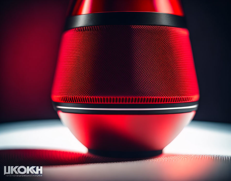 Sleek Red Electronic Device with Textured Surface on Dark Background