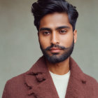 Bearded man in brown coat and white shirt with neutral expression