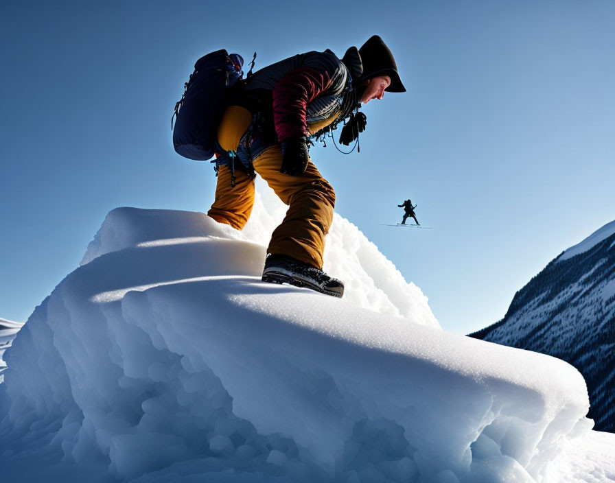 man climbing on snow rock