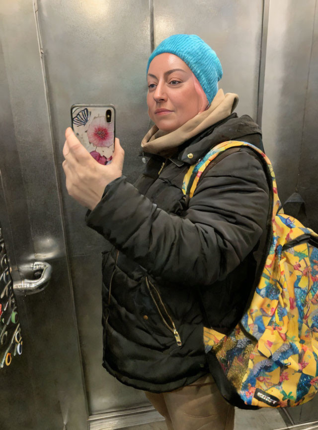Person in Blue Beanie Selfie Mirror Shot with Phone and Stylish Outfit