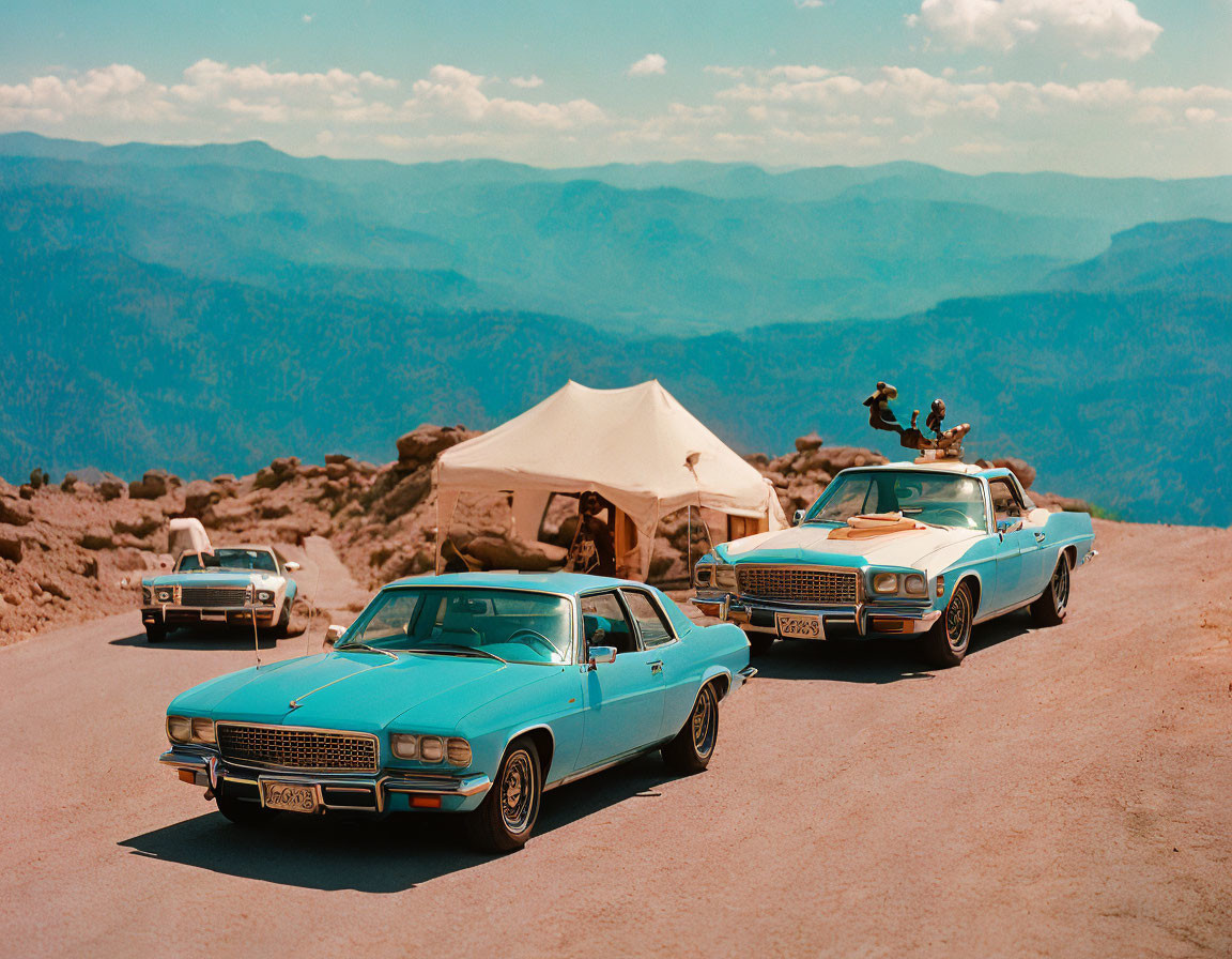 Classic cars on mountain road overlook forested hills and camping tent