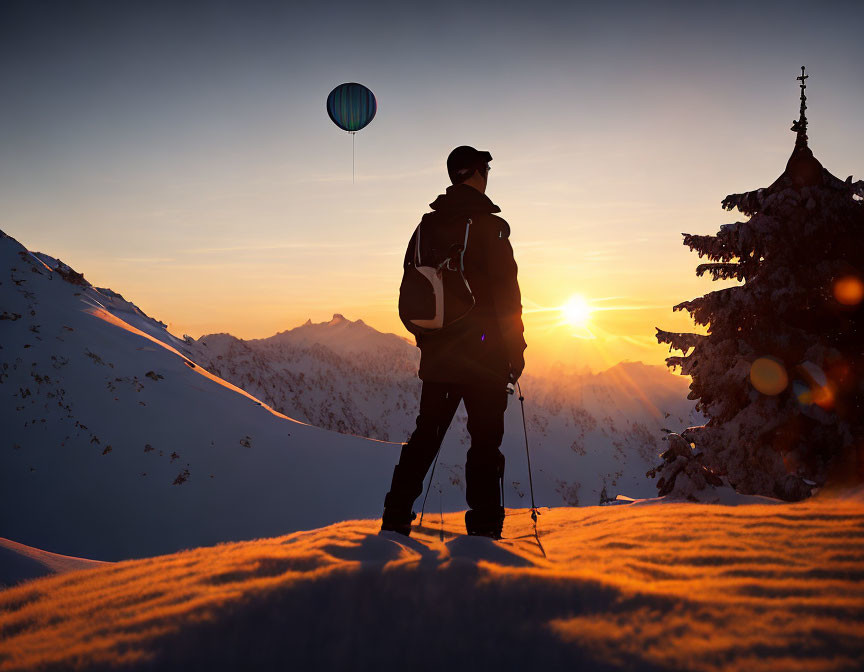Person in winter gear gazes at hot air balloon over snowy mountain at sunset