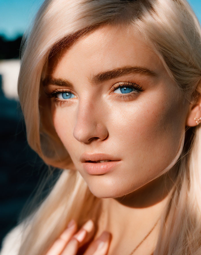 Blonde woman with blue eyes in golden hour lighting