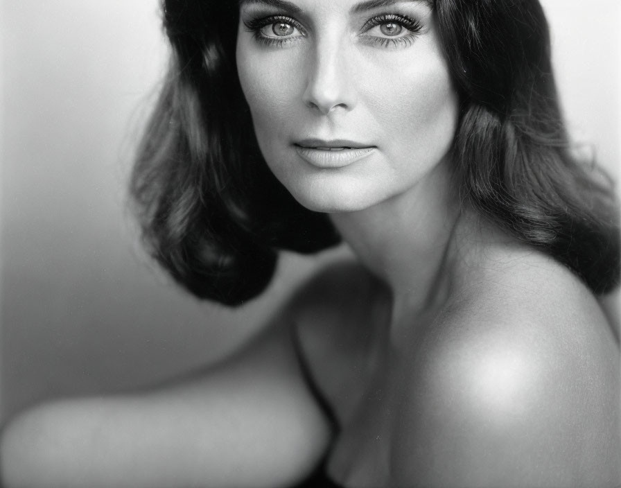 Monochrome portrait of woman with dark hair and captivating eyes
