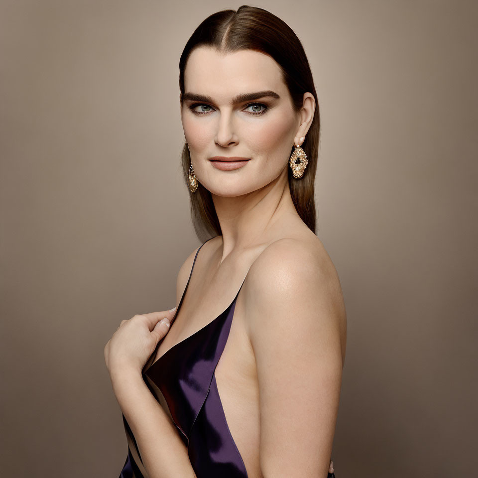 Woman with Dark Hair in Satin Purple Dress and Golden Earrings