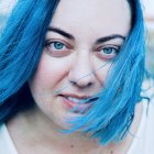 Detailed digital portrait of a woman with blue hair and captivating eyes