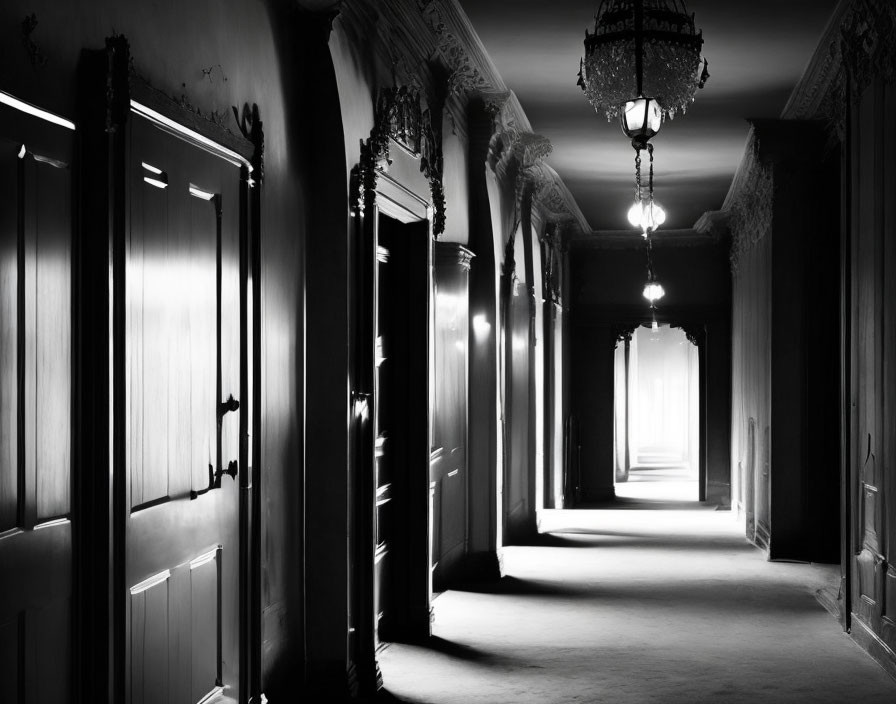 Elegant monochrome hallway with closed doors and chandeliers