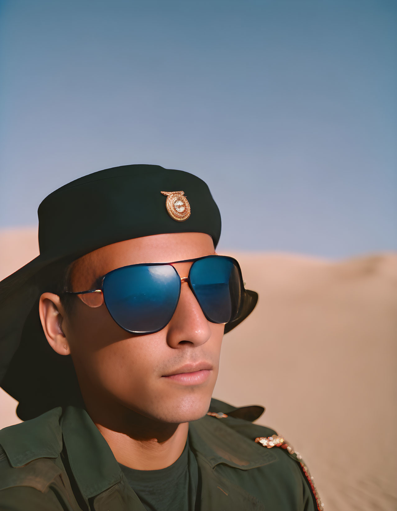 Person in Green Military Uniform with Beret and Aviator Sunglasses in Desert Setting