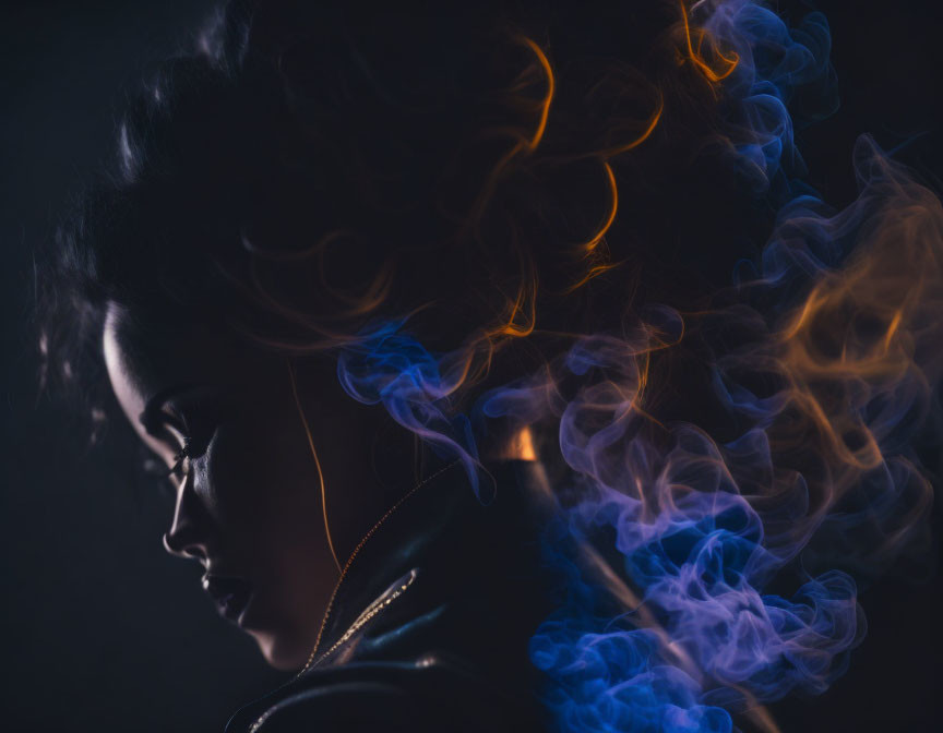 Voluminous hair woman in ethereal blue and orange smoke on dark background