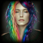 Portrait of person with rainbow-colored curly hair and freckles on dark background