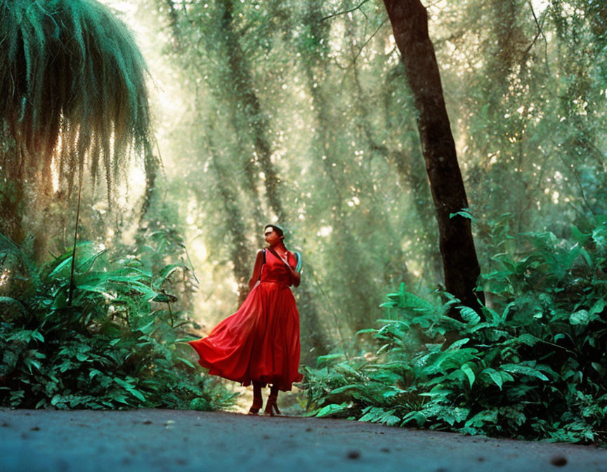 Person in Red Dress Surrounded by Greenery and Trees