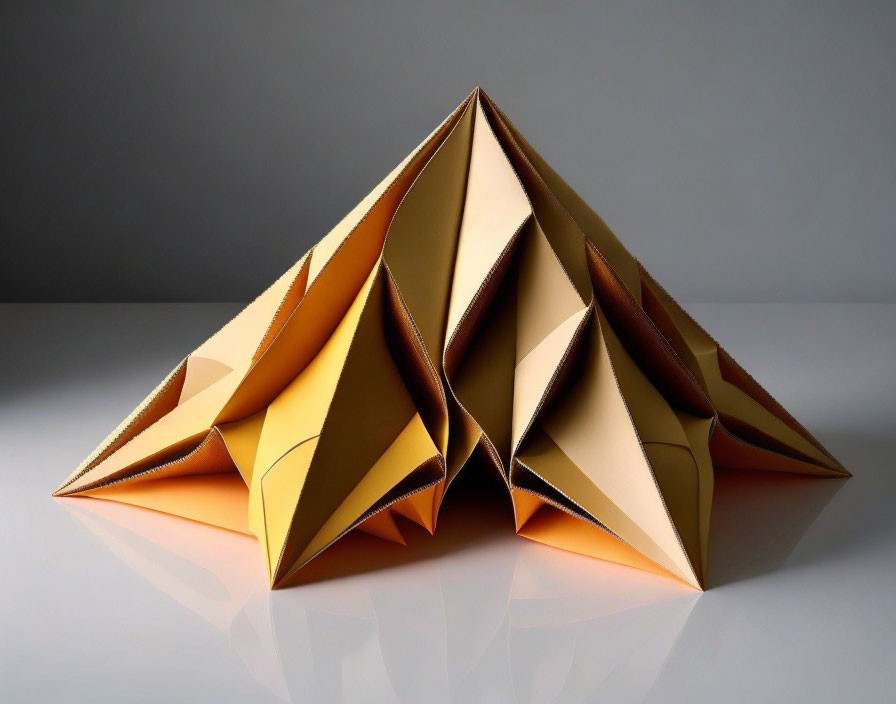 Symmetrical brown and cream paper origami on grey background